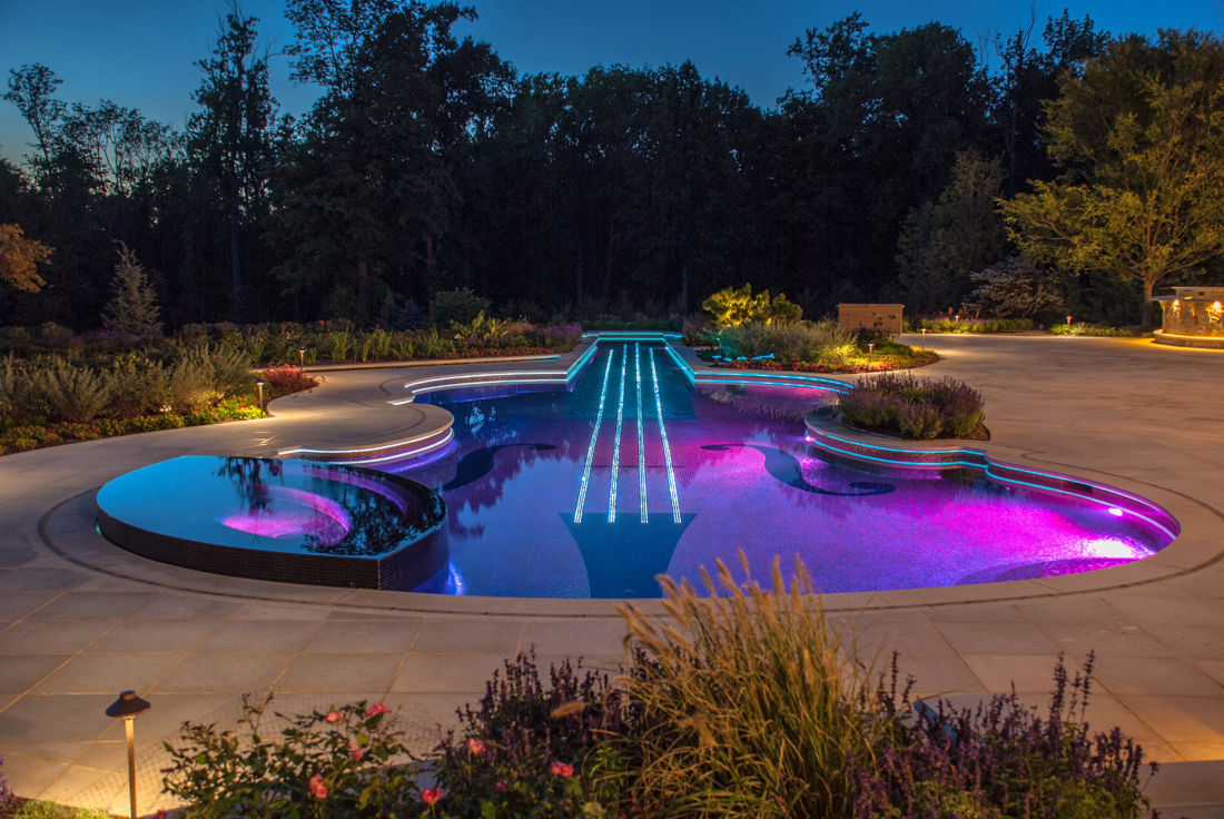 interesting-design-exterior-landscape-lighting-ideas-violin-shape-swimming-pool-blue-purple-colors-led-lights-under-water-stone-walkway-upper-lights-garden-lamps-pretty-garden-exterior-landscape-ligh